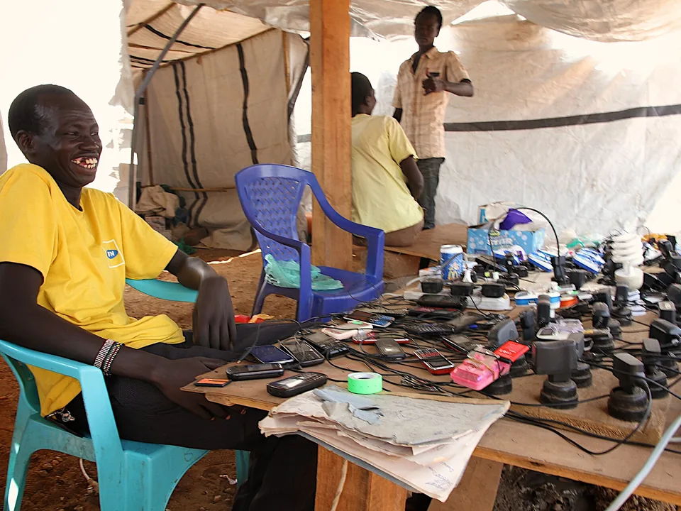 Commerçant africain utilisant son téléphone : le mobile money crédite les bénéficiaires à Dakar